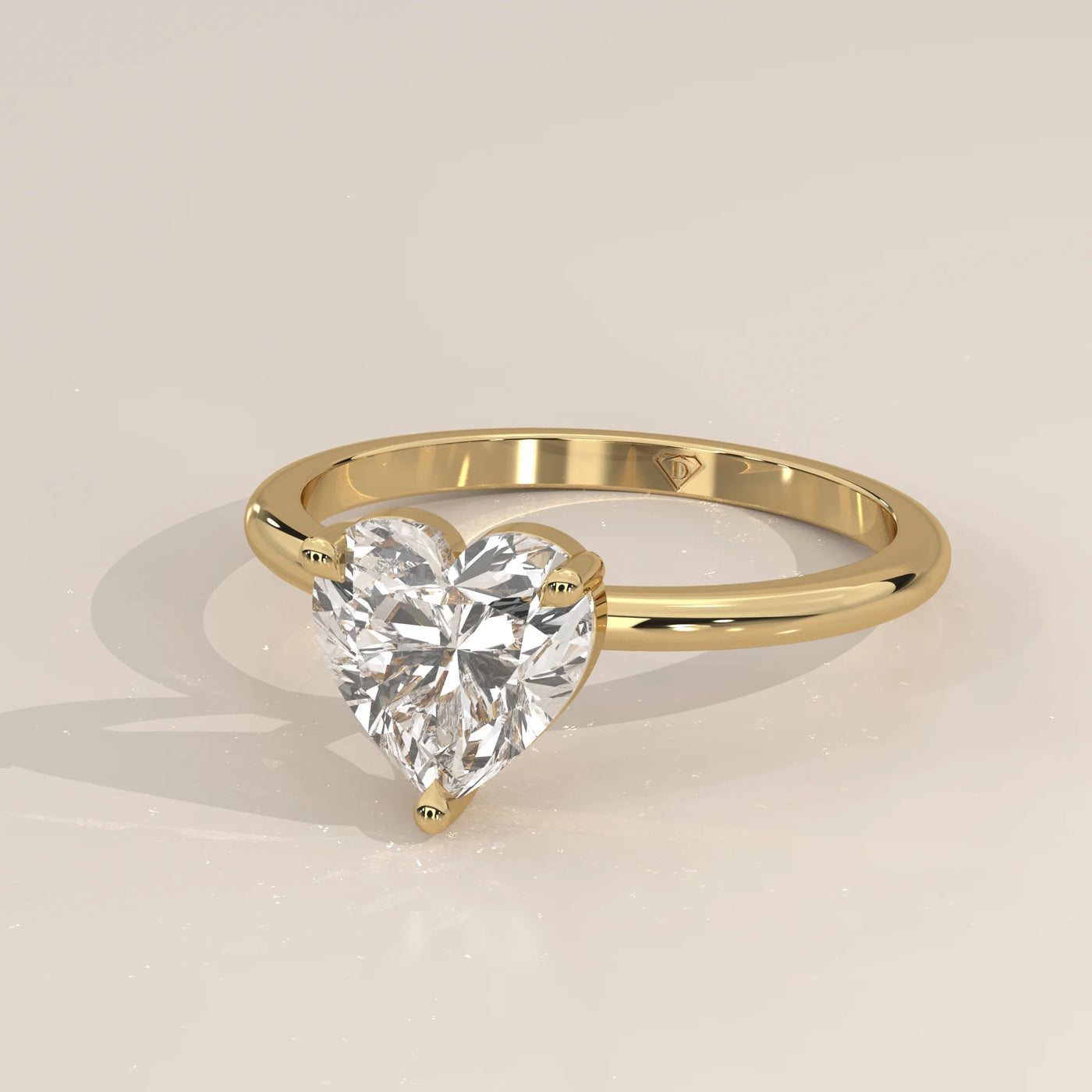 Yellow gold ring with a heart-shaped diamond.