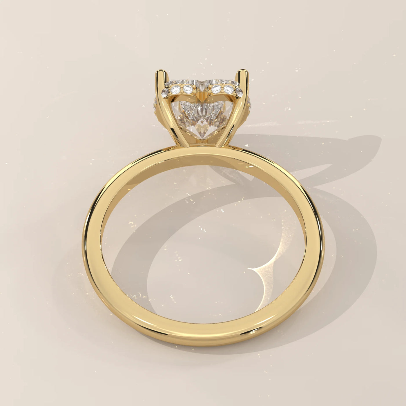 A yellow gold ring with a heart-shaped diamond and a band of small diamonds.