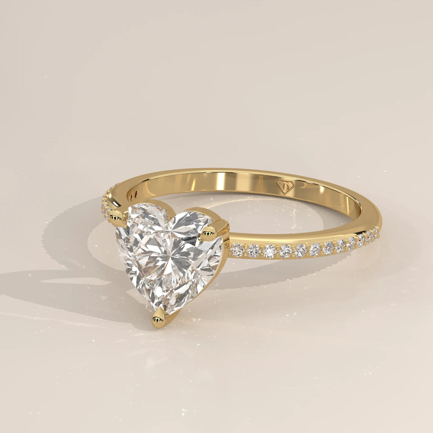 A yellow gold ring with a heart-shaped diamond and a band of small diamonds.