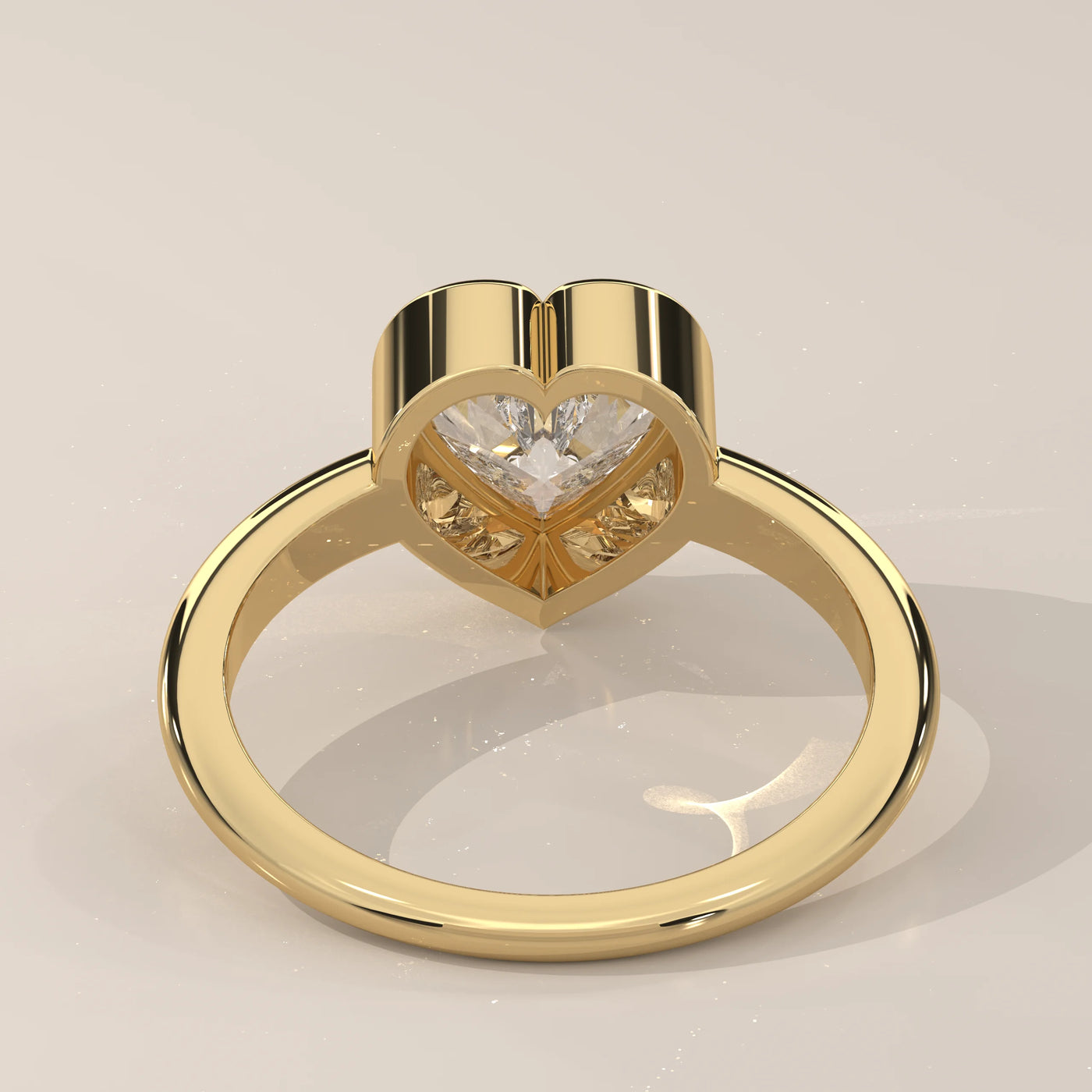 A yellow gold ring with a heart-shaped diamond and a band of small diamonds.