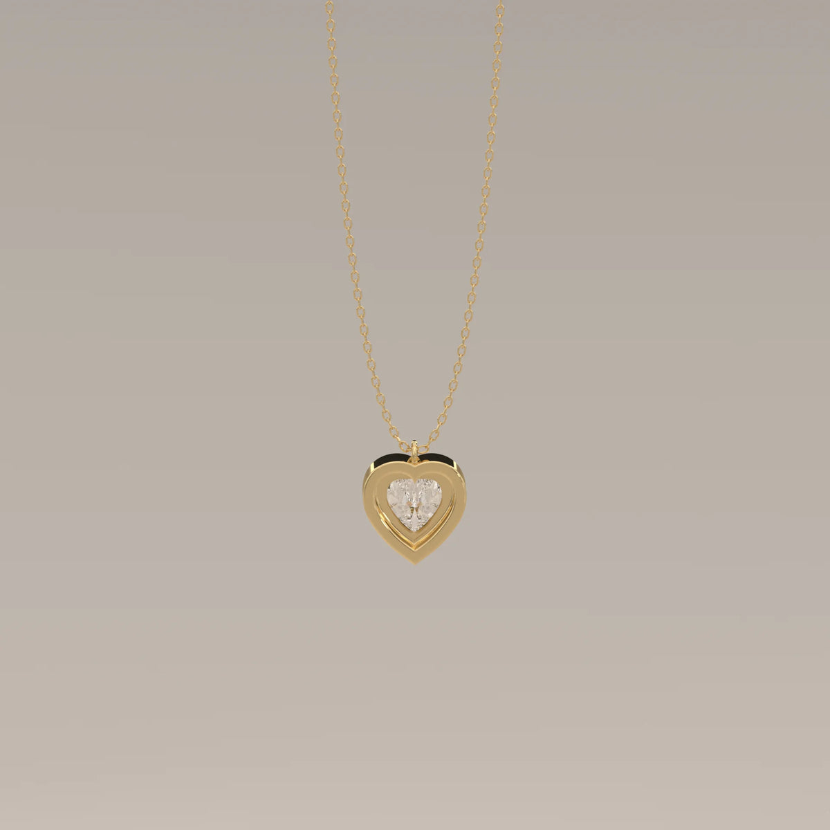 Gold heart pendant with a clear stone on a thin gold chain.