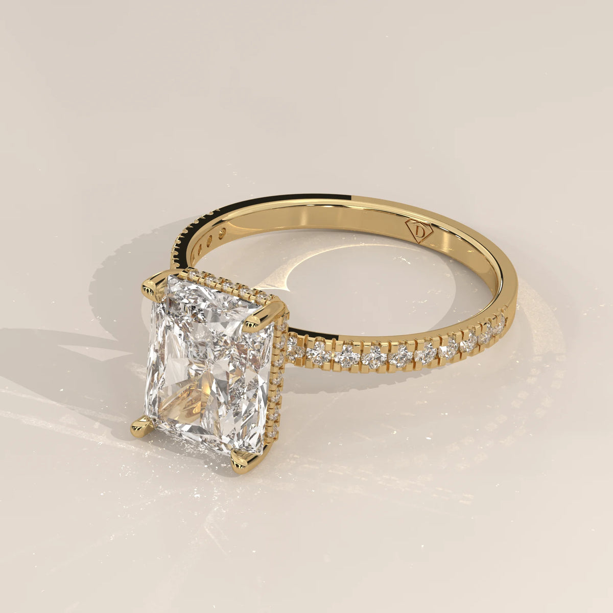 Ivory 5 Carat Radiant Lab Grown Diamond Ring, Hidden Halo Pave Band in yellow gold, shown from the side.