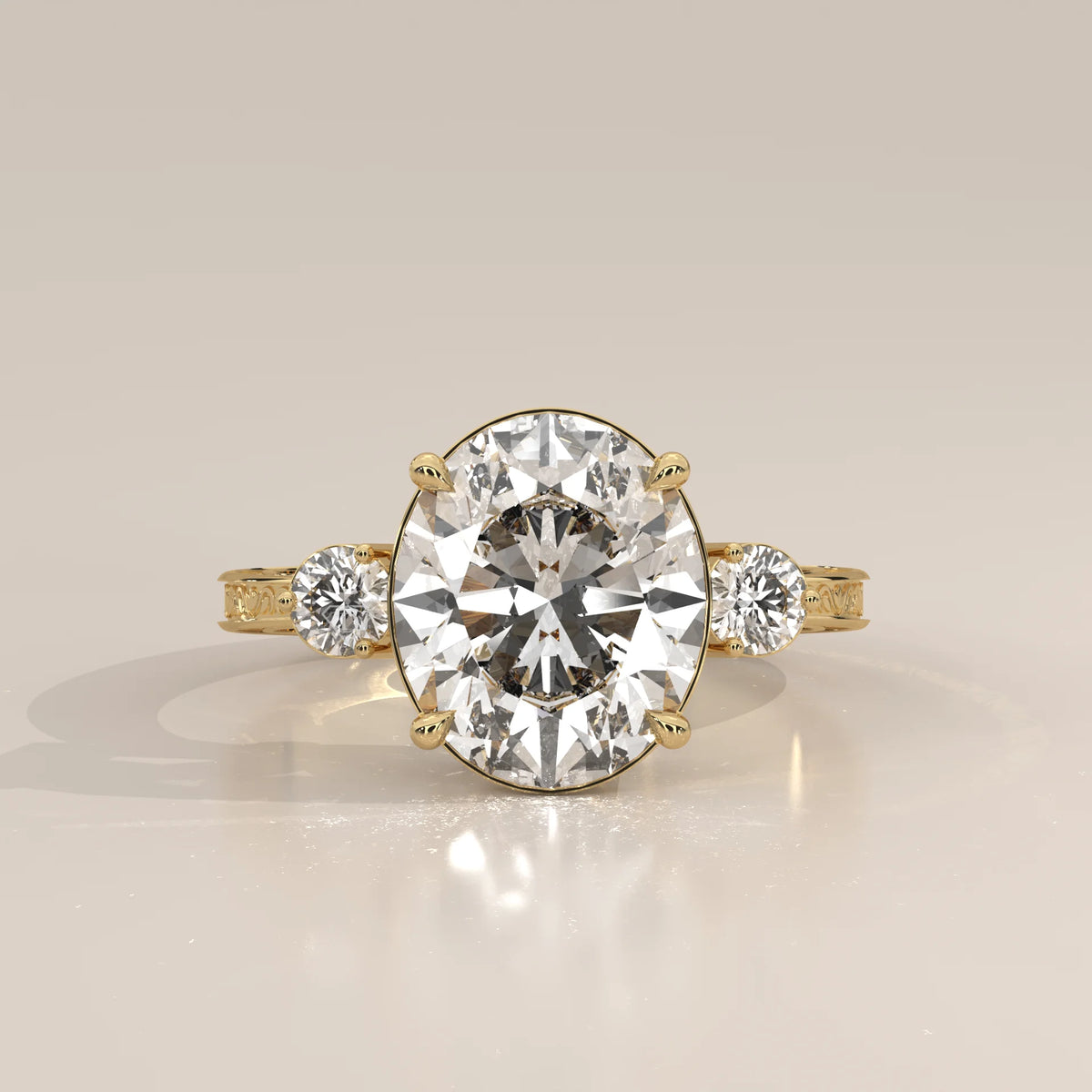 Karly 5 Carat Oval Lab Grown Diamond Three Stone Ring, Engraved Band in yellow gold, photographed head-on.