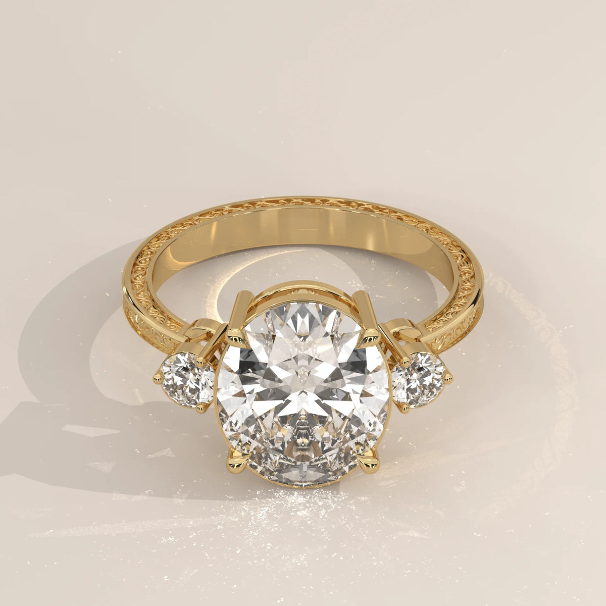 Karly 5 Carat Oval Lab Grown Diamond Three Stone Ring, Engraved Band in yellow gold, shown from the front.