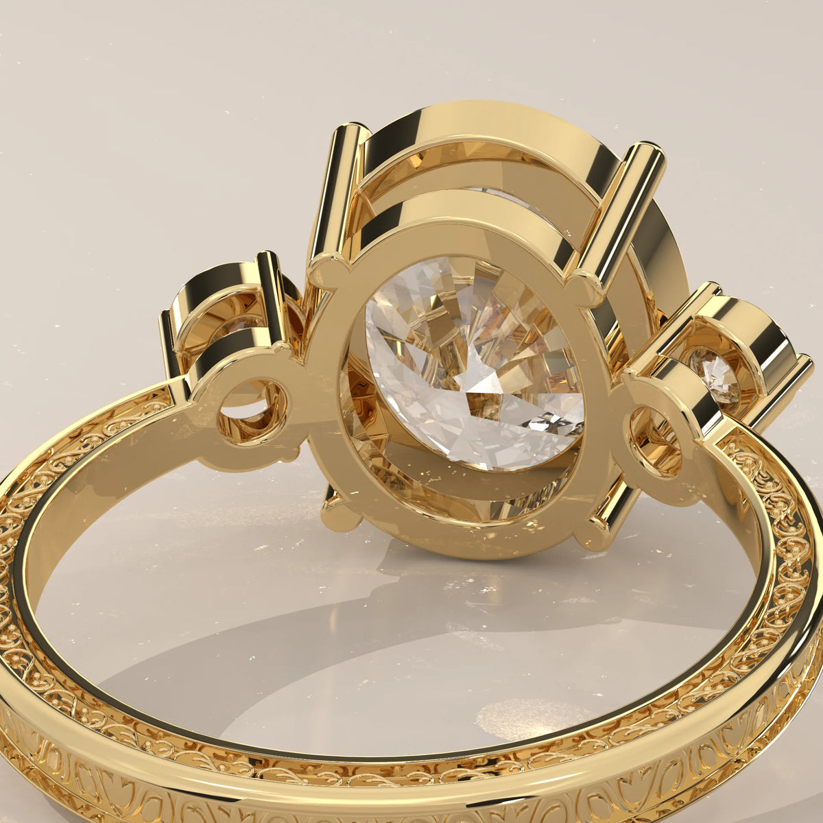Karly 5 Carat Oval Lab Grown Diamond Three Stone Ring, Engraved Band in yellow gold, product photograph on a plain background.