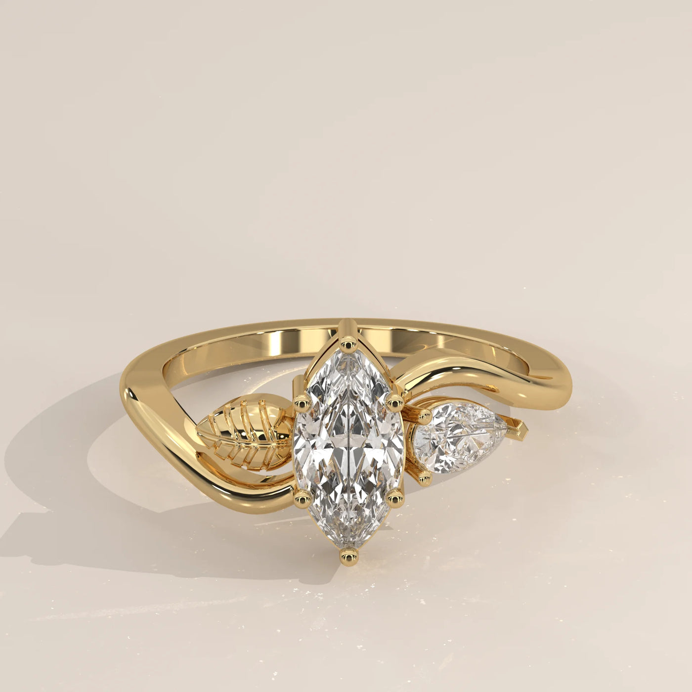 A marquise diamond ring with pear shape side stones and leaf accents.
