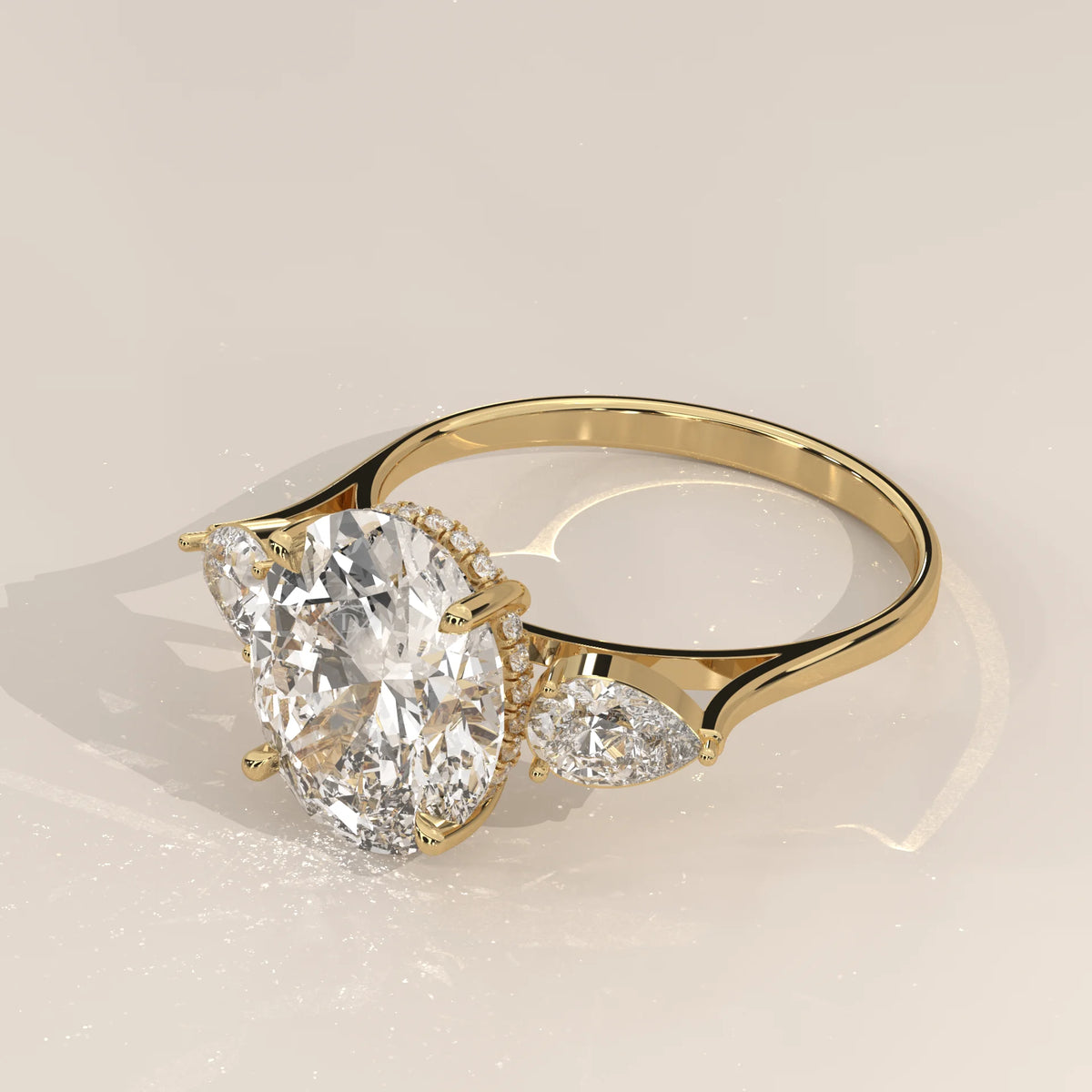 Lerrayki 5 Carat Oval Lab Grown Diamond Three Stone Ring, Pear Sides in yellow gold, shown at an angle.