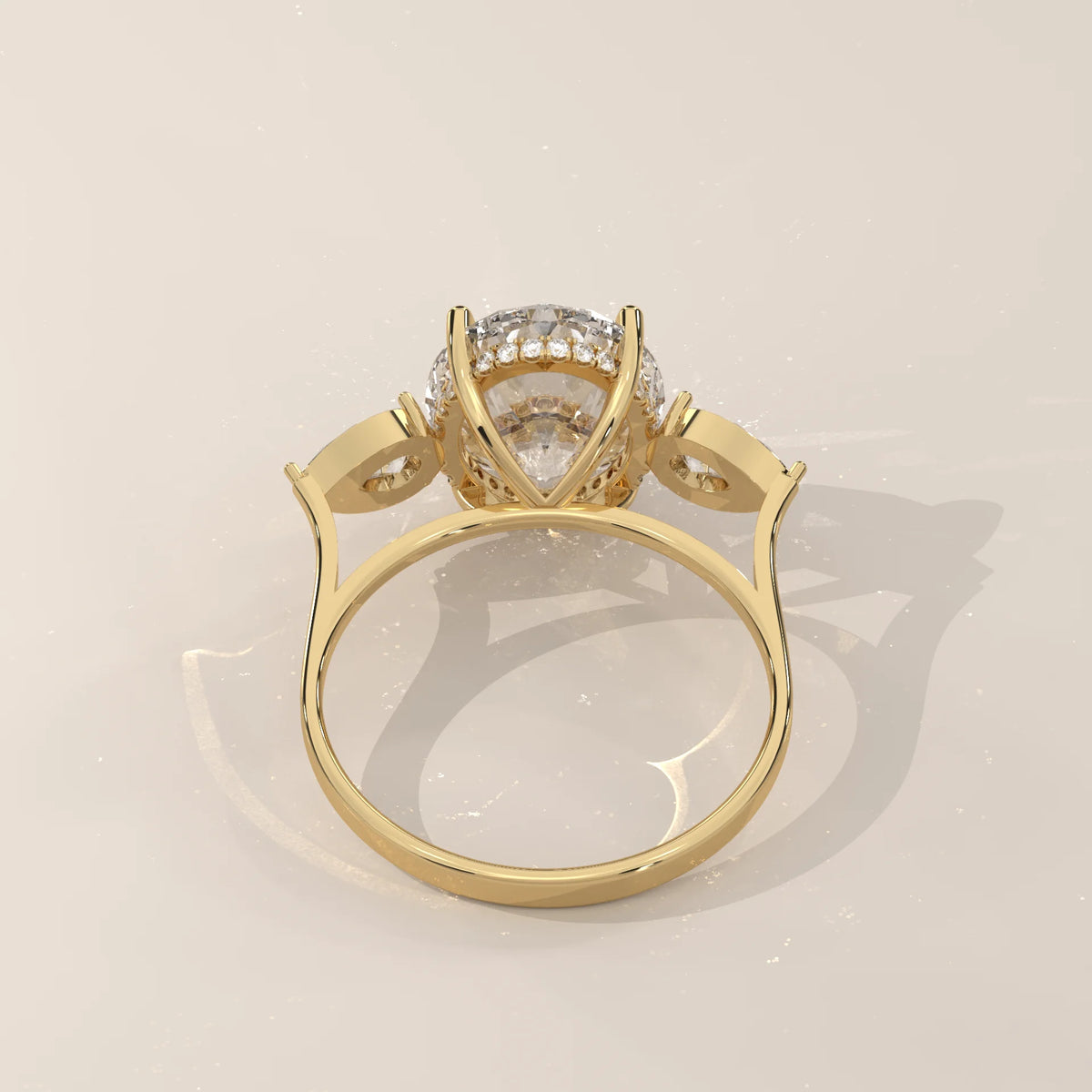 Lerrayki 5 Carat Oval Lab Grown Diamond Three Stone Ring, Pear Sides in yellow gold, shown on a plain background.