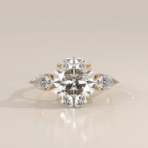 Lerrayki 5 Carat Oval Lab Grown Diamond Three Stone Ring, Pear Sides in yellow gold, photographed head-on.