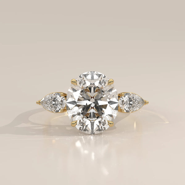 Lerrayki 5 Carat Oval Lab Grown Diamond Three Stone Ring, Pear Sides in yellow gold, photographed head-on.
