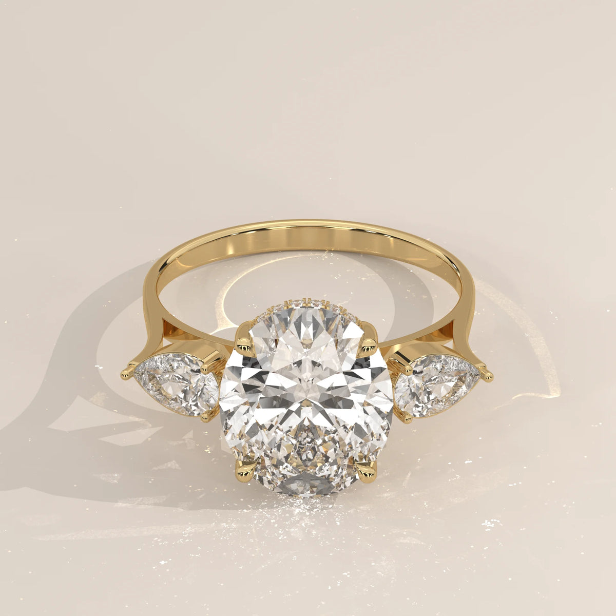Lerrayki 5 Carat Oval Lab Grown Diamond Three Stone Ring, Pear Sides in yellow gold, shown from the front.