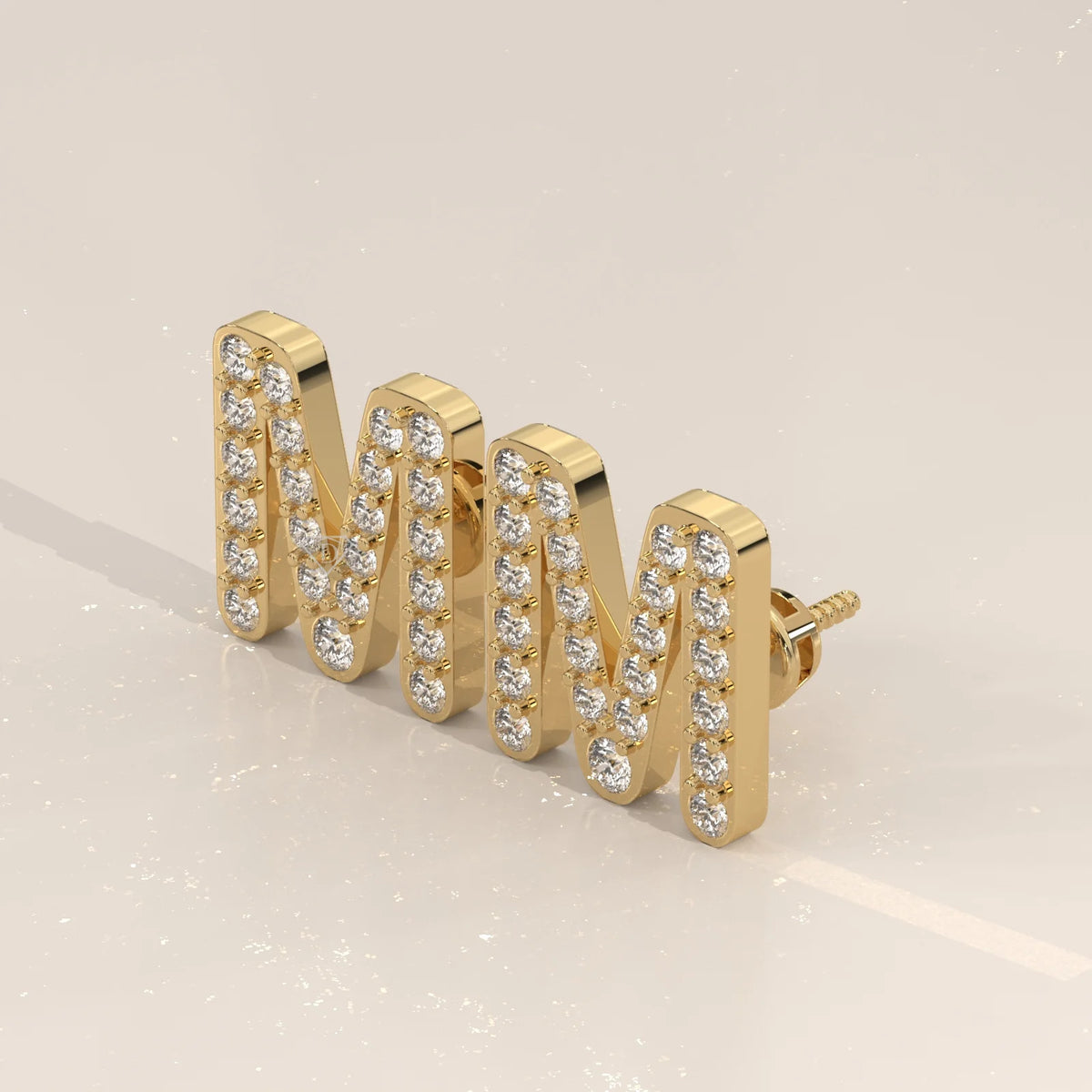 Letter M Initial Pave Lab Grown Diamond Stud Earrings in yellow gold, shown from the side.
