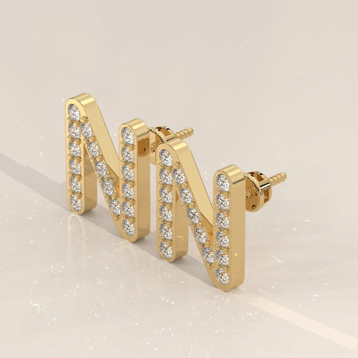 Letter N Initial Pave Lab Grown Diamond Stud Earrings in yellow gold, shown at an angle.