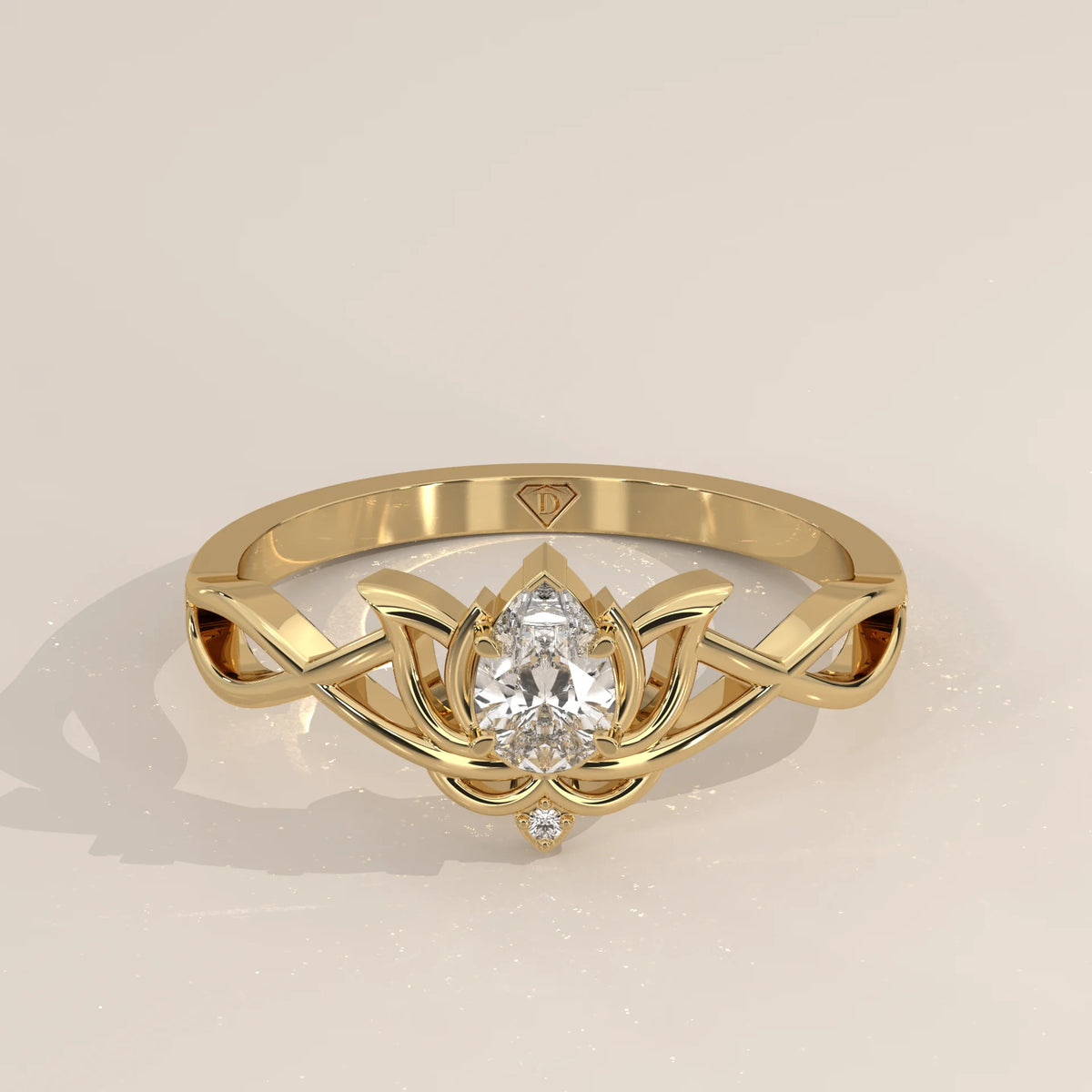 Gold ring with a pear-shaped diamond in a lotus design.