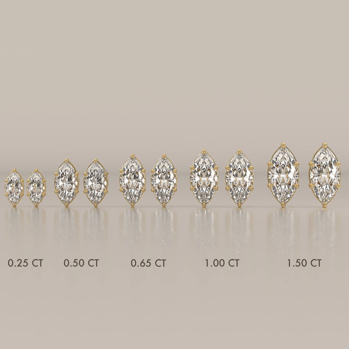 Group of marquise diamond earrings in 14k gold, shown in various sizes.