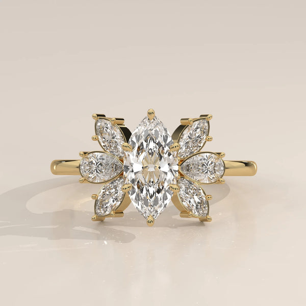 Yellow gold ring featuring a marquise-cut diamond surrounded by smaller stones in a floral design.