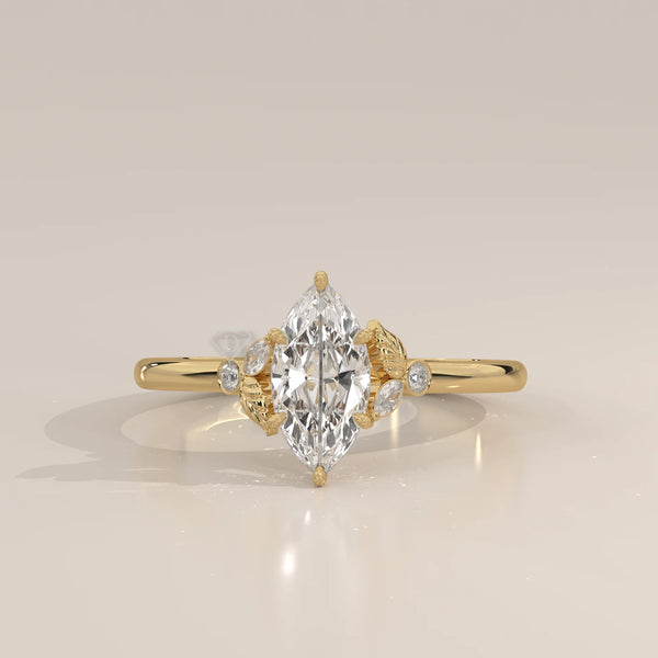 Gold ring with a marquise-cut diamond and accent stones.