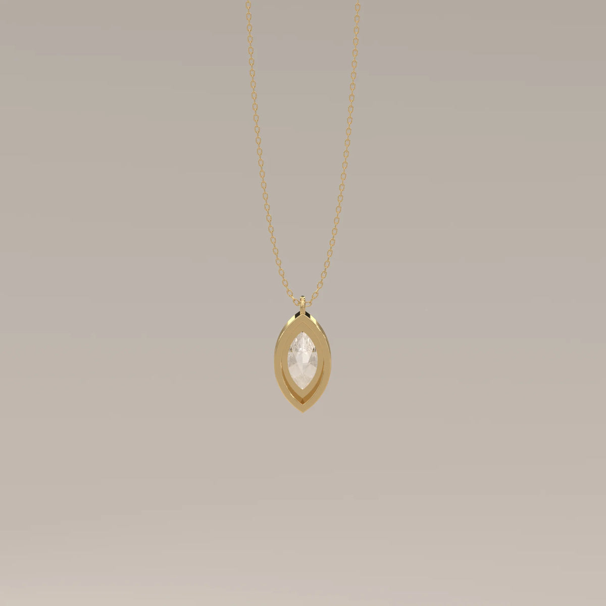 A delicate gold necklace with a marquise-cut clear stone.
