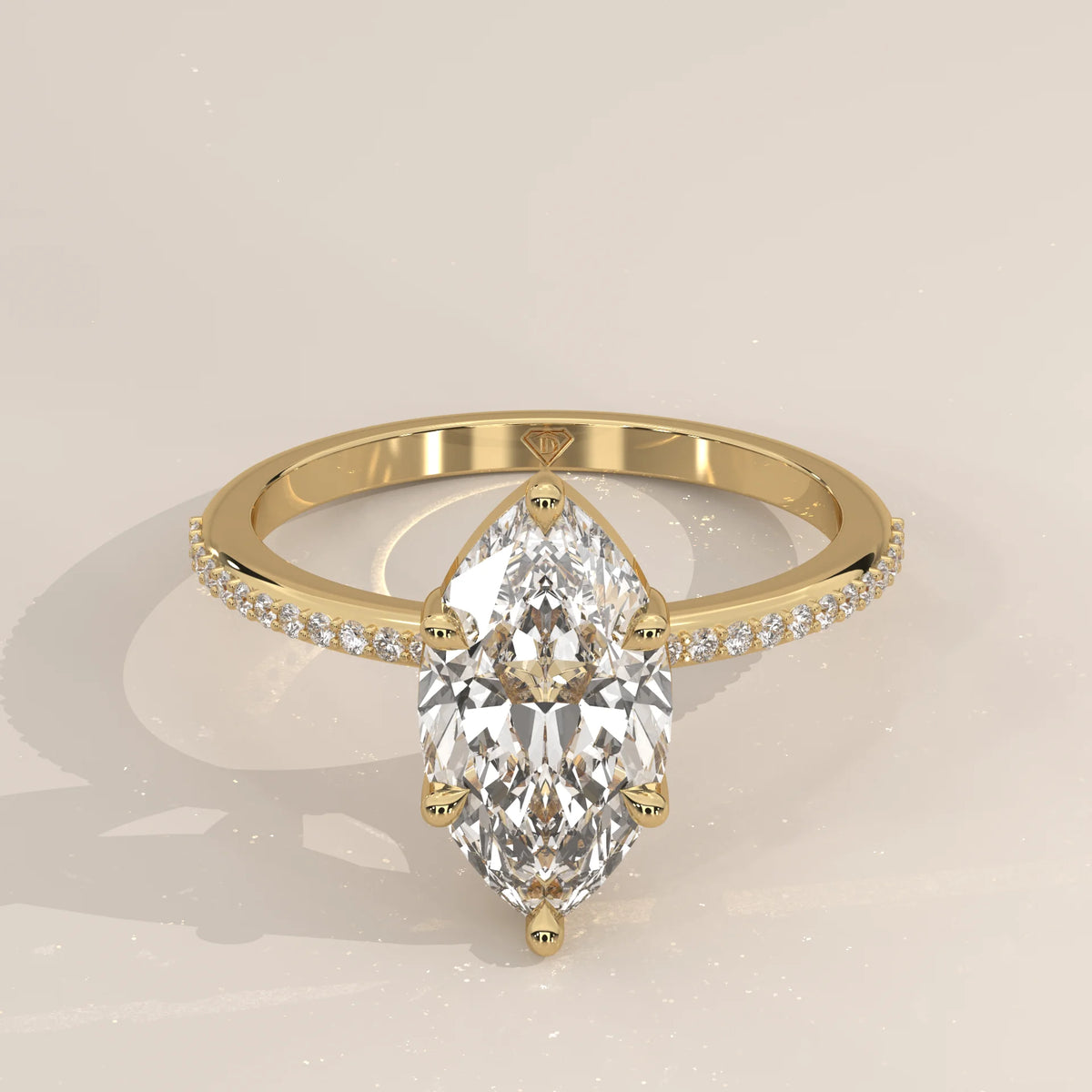 A delicate 14k gold ring with a large marquise-cut diamond and pave band.