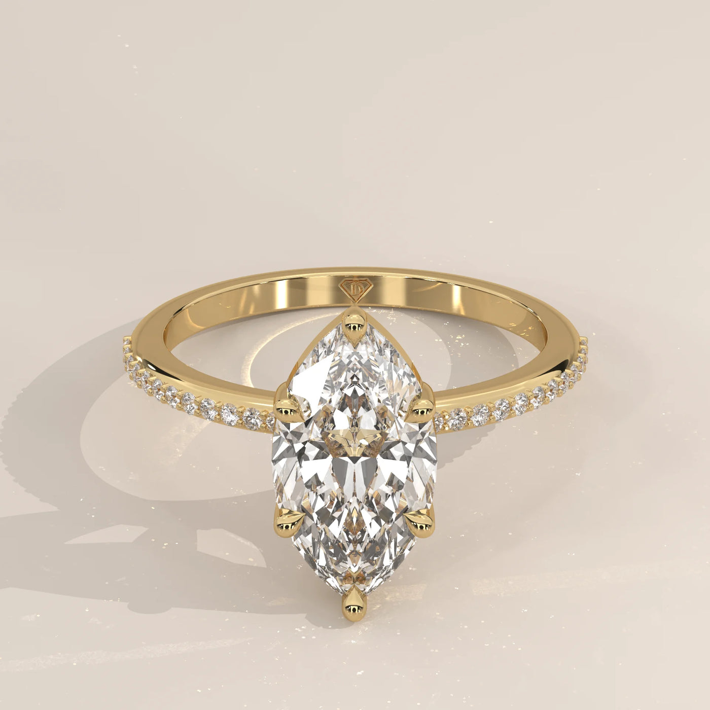 A delicate 14k gold ring with a large marquise-cut diamond and pave band.