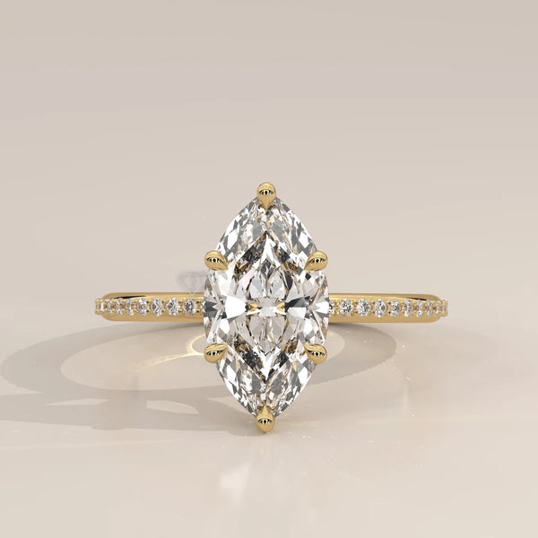 A delicate 14k gold ring with a large marquise-cut diamond and pave band.