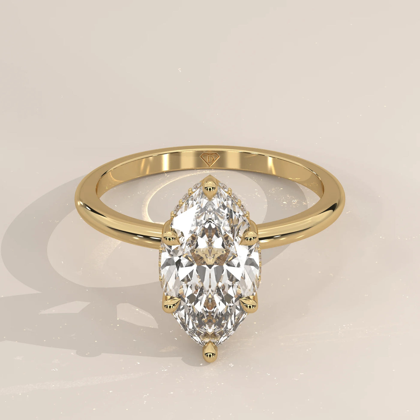 A delicate 14k gold ring with a large marquise-cut diamond and pave band.