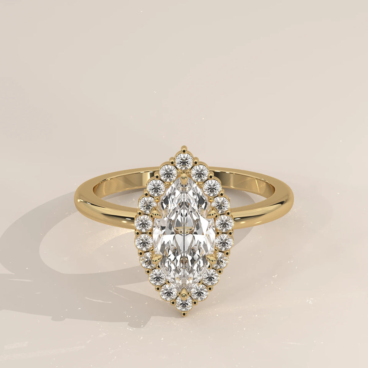 Yellow gold ring featuring a marquise-cut diamond encircled by smaller diamonds.