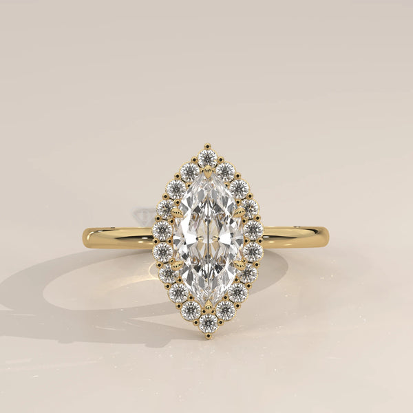 Yellow gold ring featuring a marquise-cut diamond encircled by smaller diamonds.