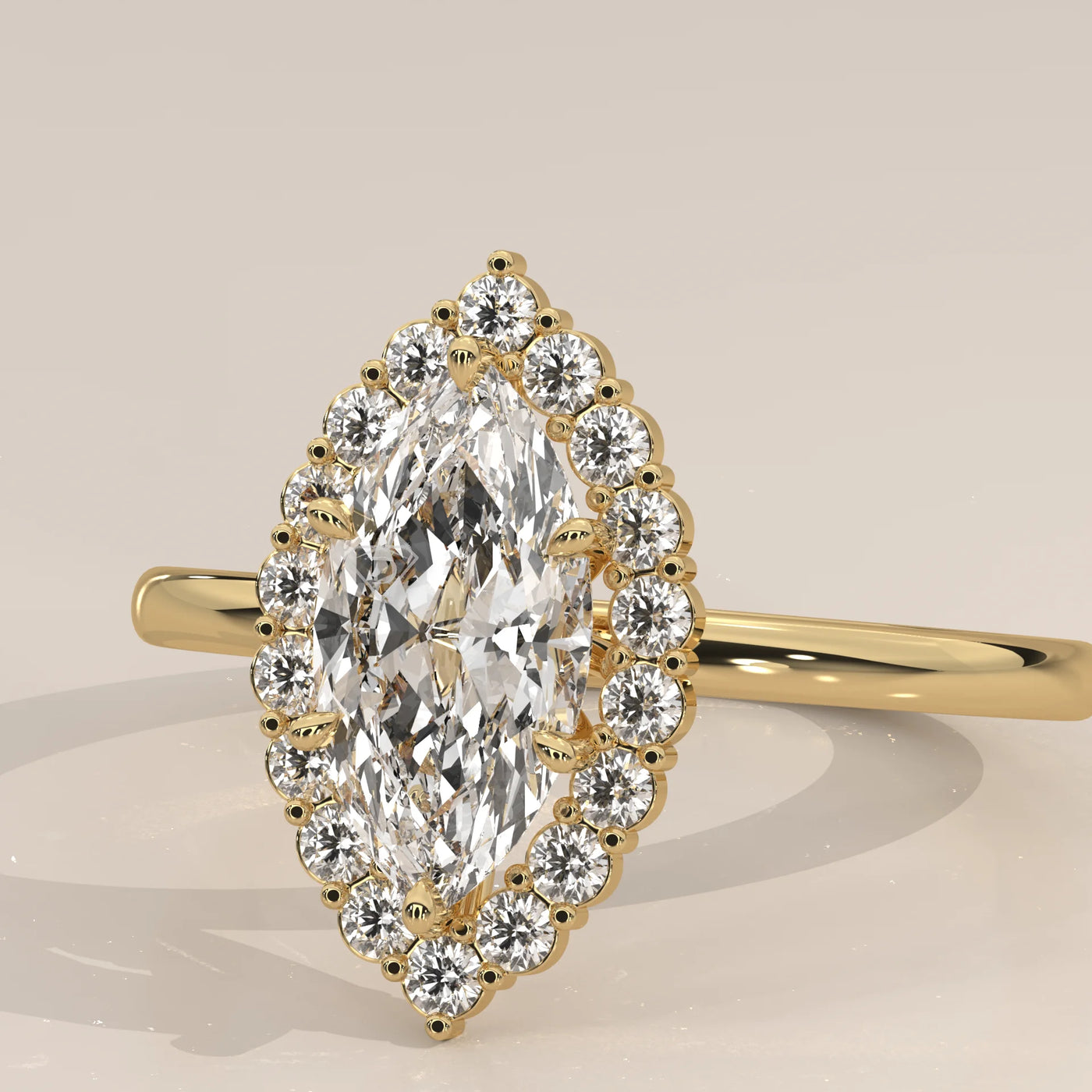Yellow gold ring featuring a marquise-cut diamond encircled by smaller diamonds.