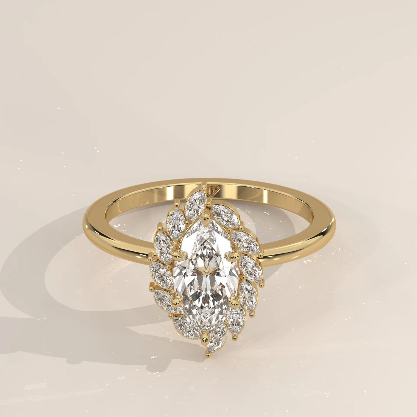 Yellow gold ring featuring a marquise-cut diamond encircled by smaller diamonds.
