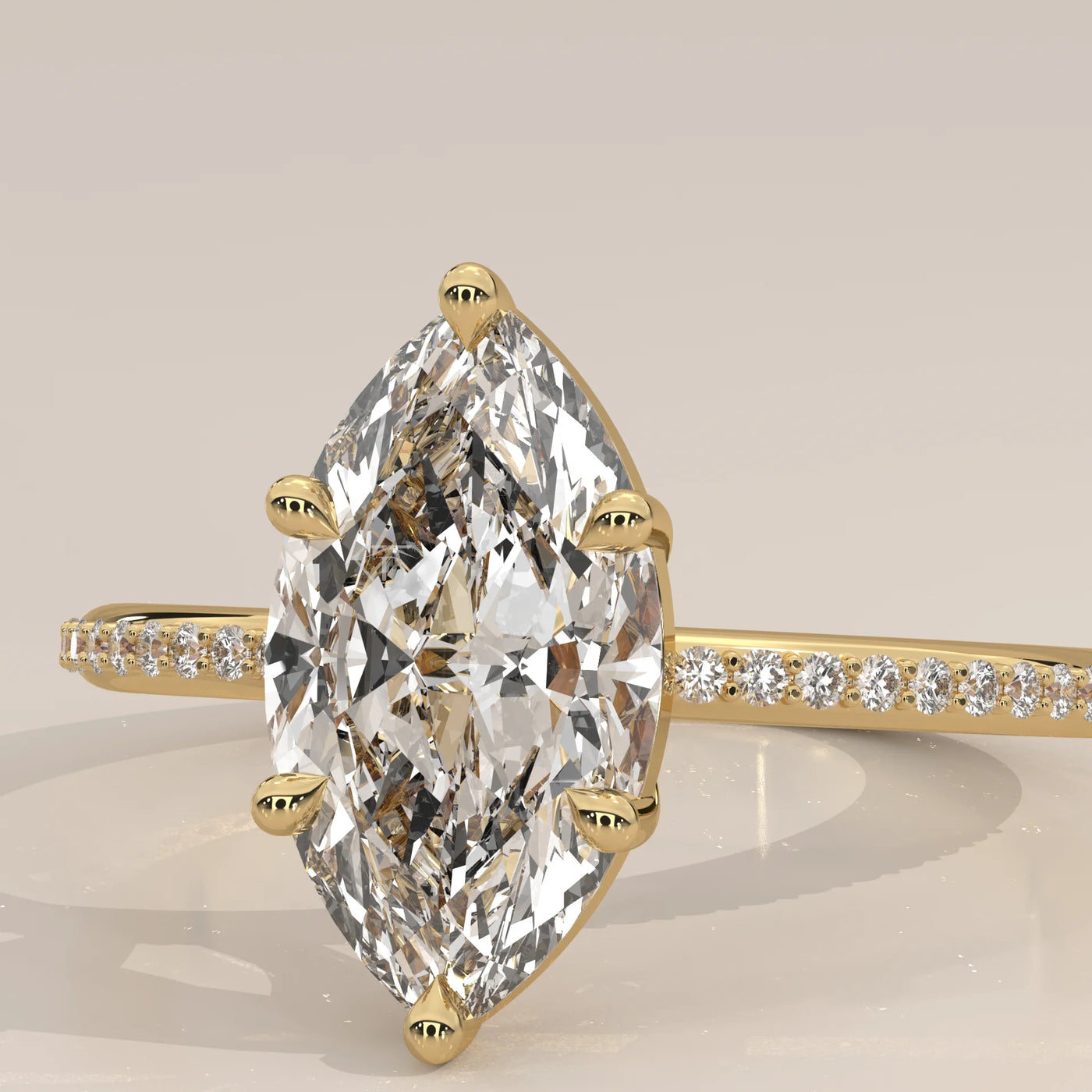 Yellow gold ring with a large marquise-cut diamond and small accent stones.