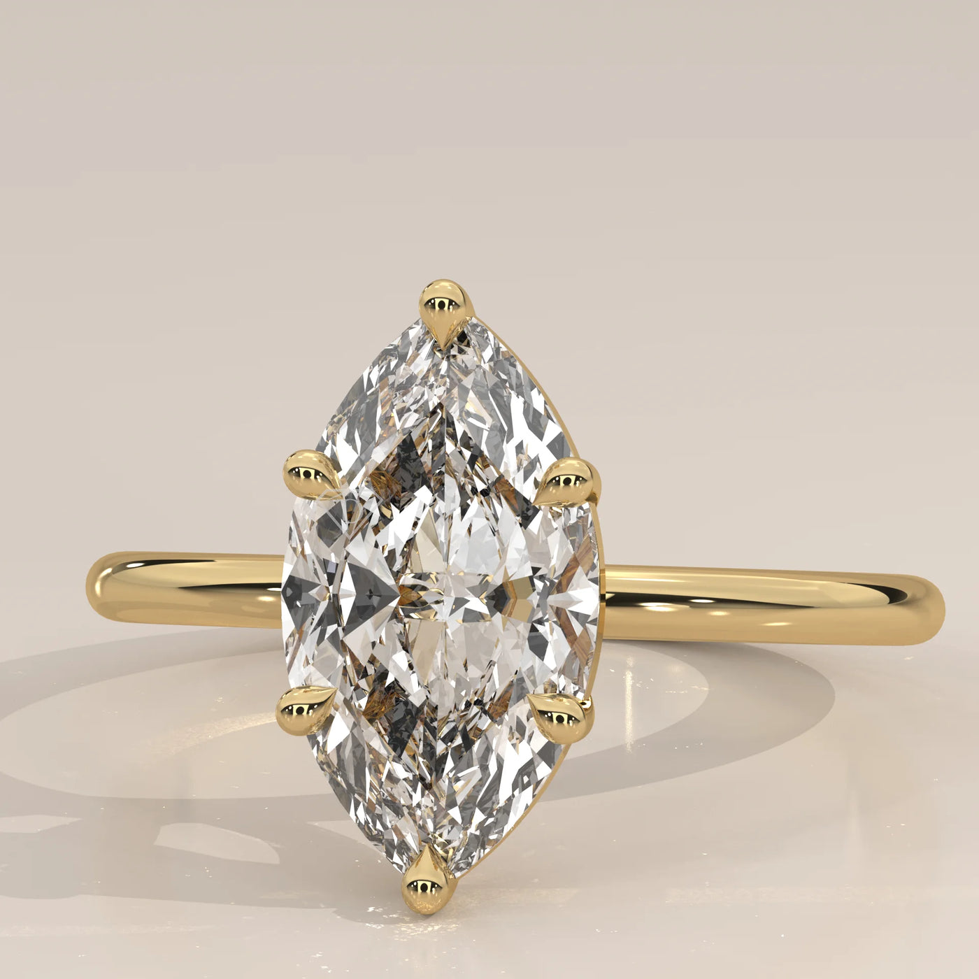 A 14k yellow gold ring with a large marquise-cut diamond.