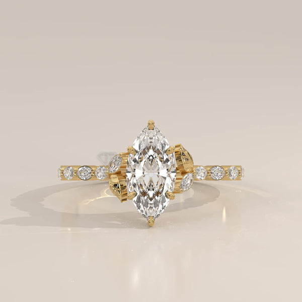 Yellow gold ring with a large marquise-cut diamond and smaller accent stones.