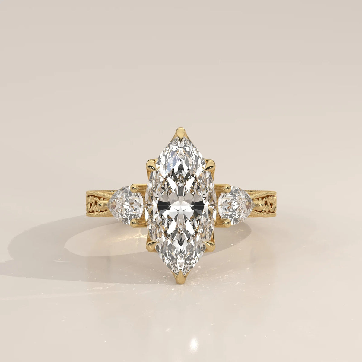 Front view: Marquise Diamond Three Stone Ring with Pear Side Stones and Vintage Engraved Band in 14K Yellow Gold – Lab Grown – Driona Jewels