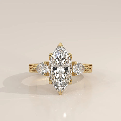 Front view: Marquise Diamond Three Stone Ring with Pear Side Stones and Vintage Engraved Band in 14K Yellow Gold – Lab Grown – Driona Jewels
