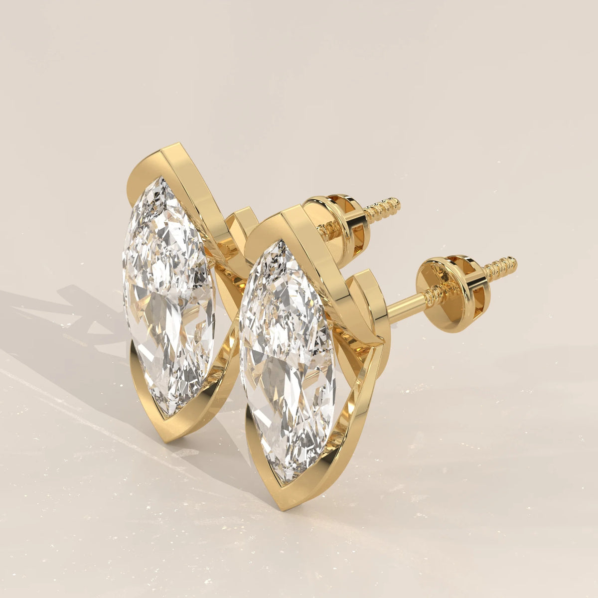 Marquise Lab Grown Diamond Studs with Pointed Tip Bezels in yellow gold, shown from the side.