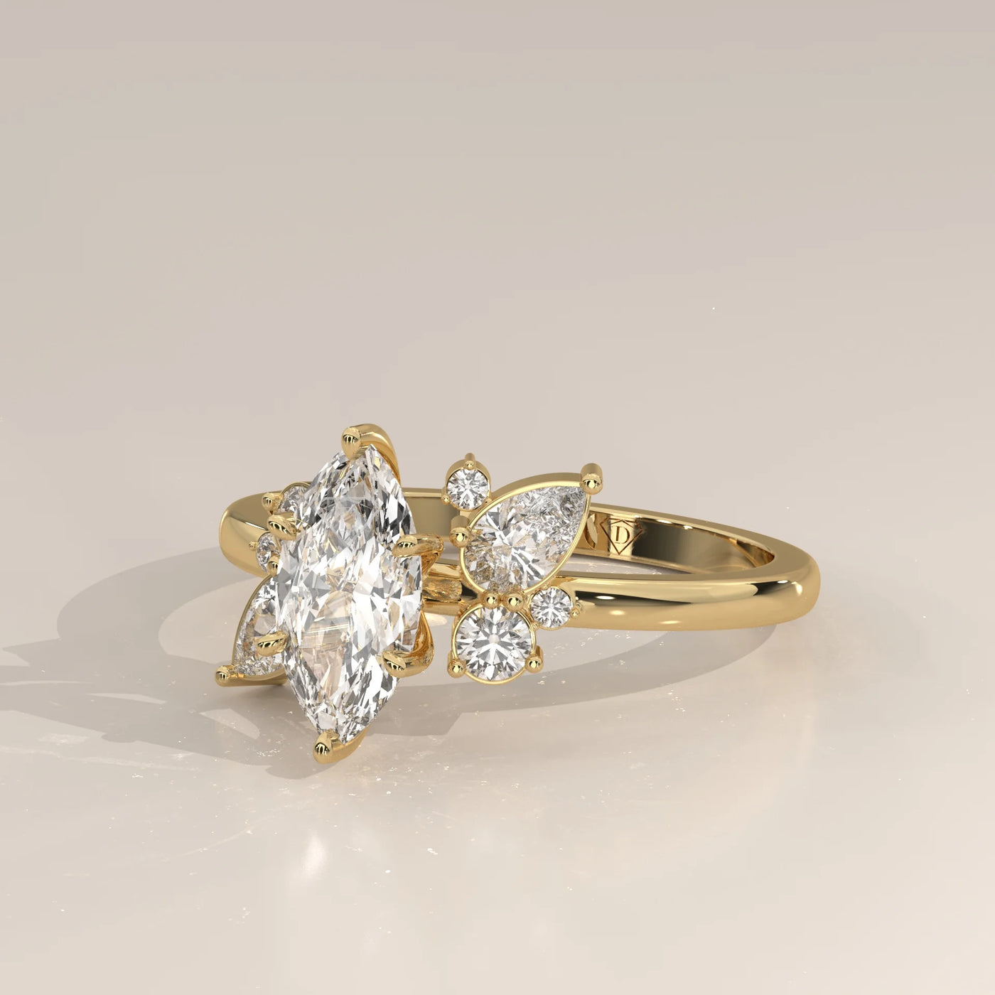 Yellow gold ring with a marquise diamond and smaller diamonds, side view.