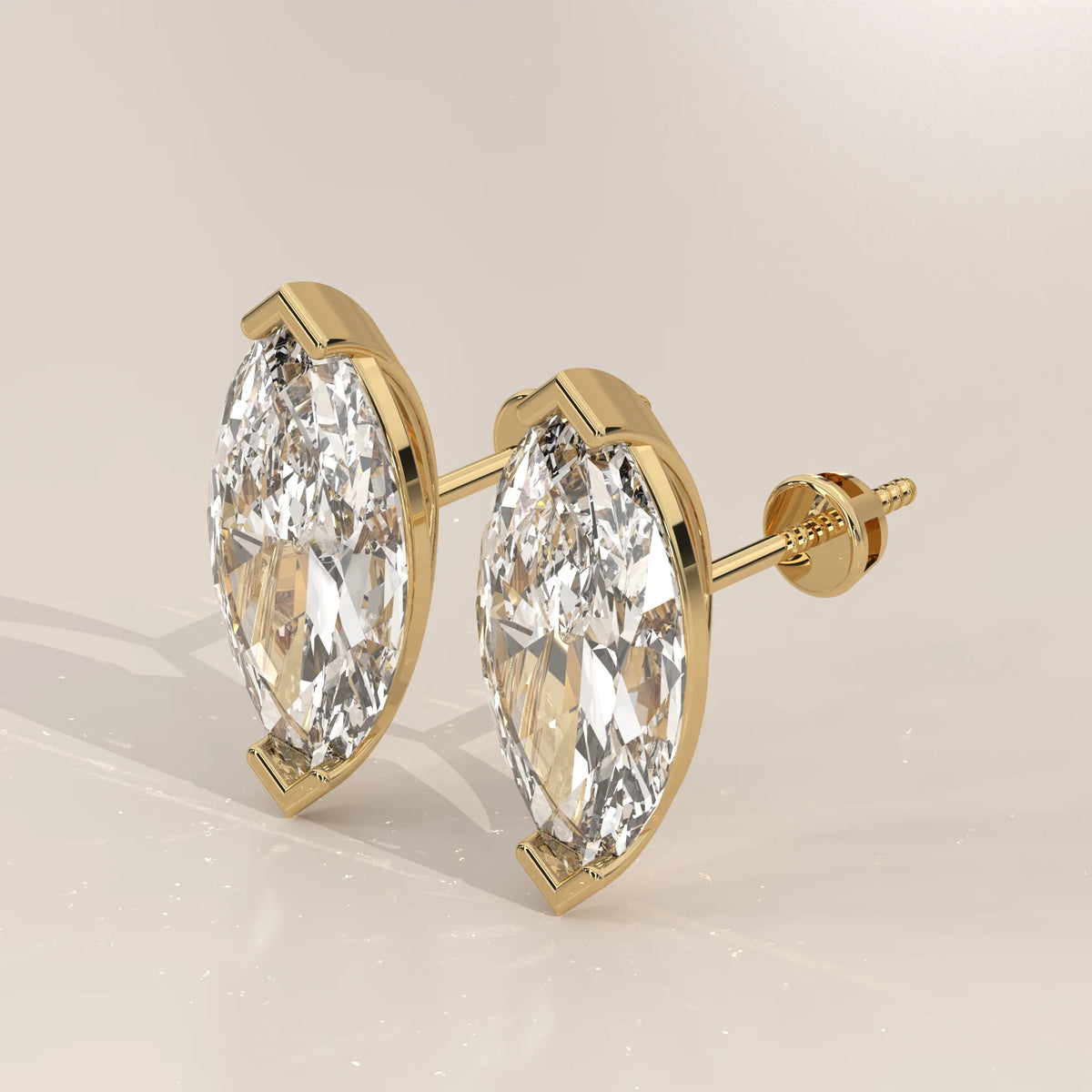 Marquise Solitaire Lab Grown Diamond Studs with V Tip Prongs in yellow gold, shown from the side.