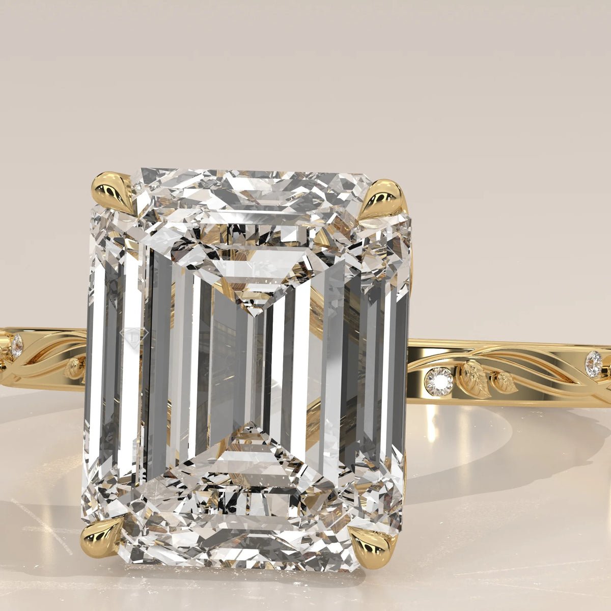 Miloise 5 Carat Emerald Cut Lab Grown Diamond Ring, Engraved Vine in yellow gold, close-up of the emerald cut and engraved leaves.