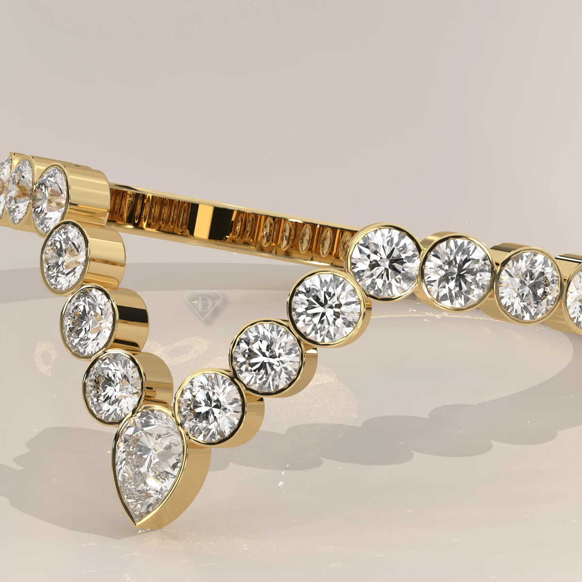 Yellow gold chevron wedding band with a bezel set pear lab grown diamond and round accents, photographed at a three-quarter angle.
