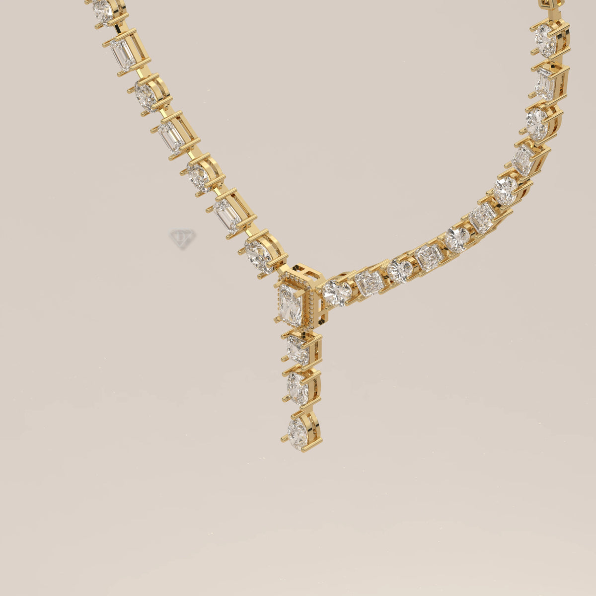 An emerald cut halo y-drop lab grown diamond necklace in yellow gold, shown at an angle.