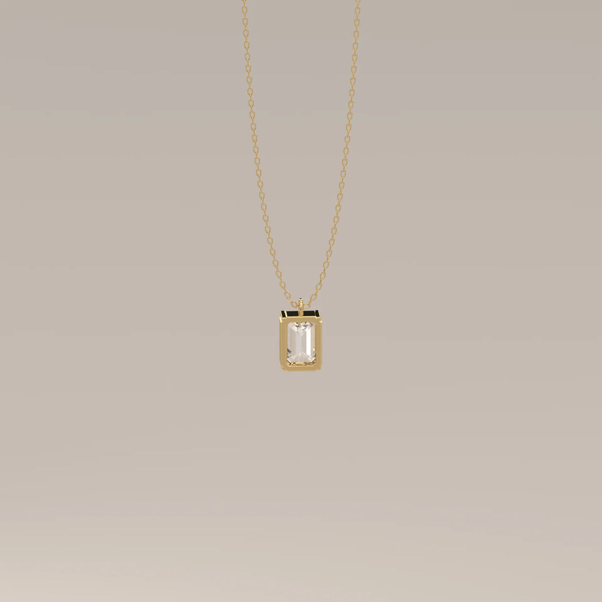 A delicate gold necklace with an emerald-cut gemstone pendant.