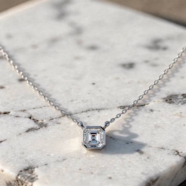 Flat Lay: Emerald Diamond Necklace with Bezel Setting in 14k White Gold - Lab Grown - Driona Jewels