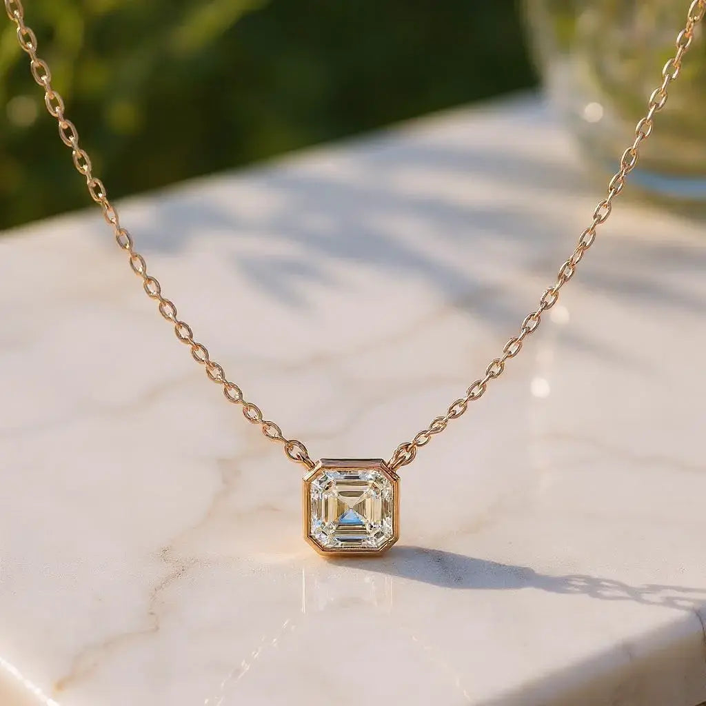 Flat Lay: Emerald Cut Diamond Necklace with Bezel Setting in 14k Yellow Gold - Lab Grown - Driona Jewels
