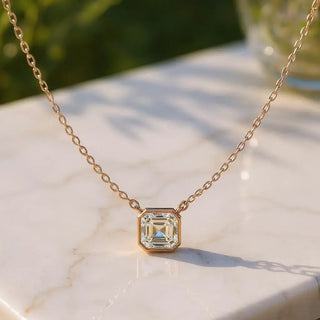 Flat Lay: Emerald Cut Diamond Necklace with Bezel Setting in 14k Yellow Gold - Lab Grown - Driona Jewels
