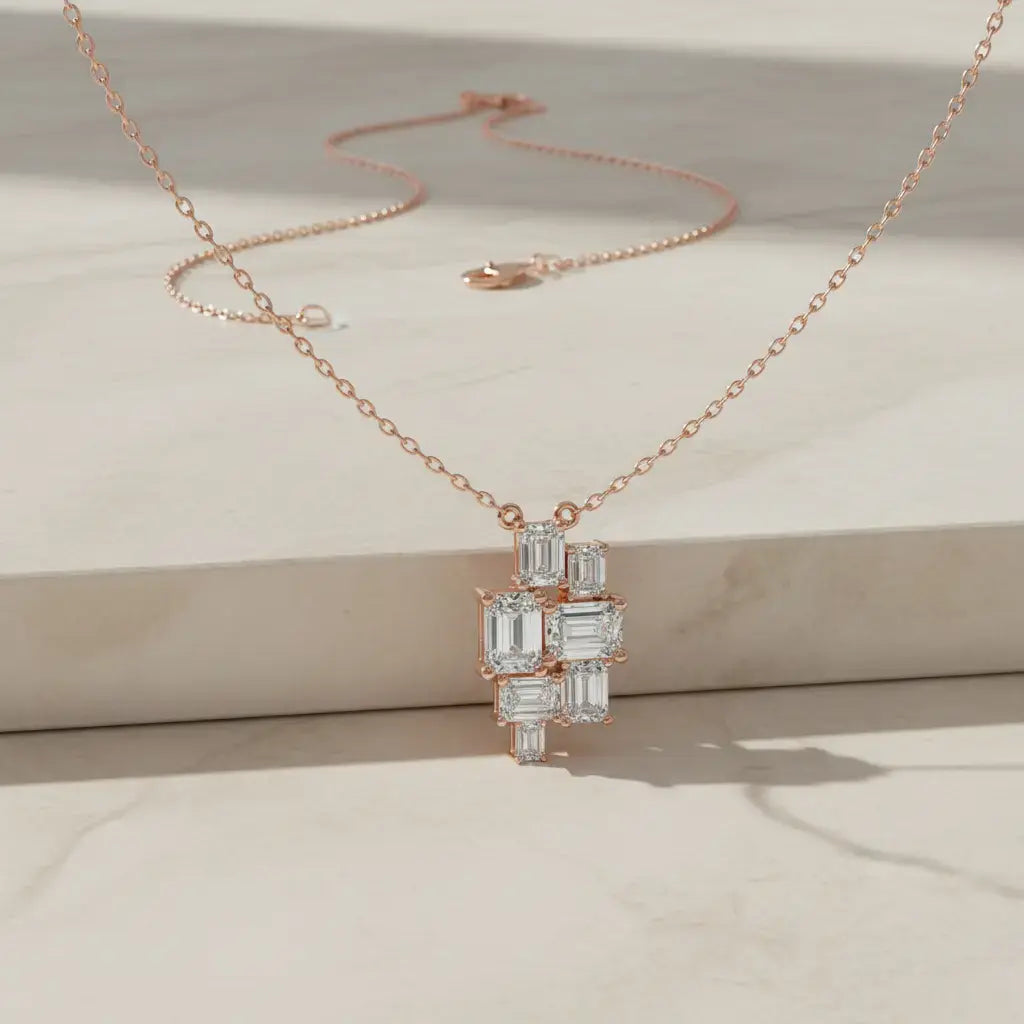 Flat Lay: Emerald Cut Diamond Necklace with Cluster Setting in 14k Rose Gold - Lab Grown - Driona Jewels