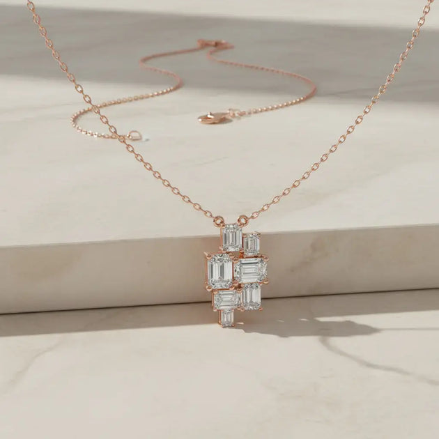 Flat Lay: Emerald Cut Diamond Necklace with Cluster Setting in 14k Rose Gold - Lab Grown - Driona Jewels