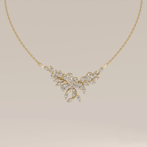 A marquise and pear lab grown diamond leaf necklace in yellow gold, shown from the front.