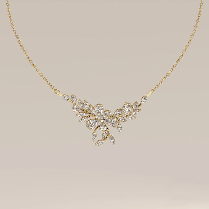 A marquise and pear lab grown diamond leaf necklace in yellow gold, shown from the front.