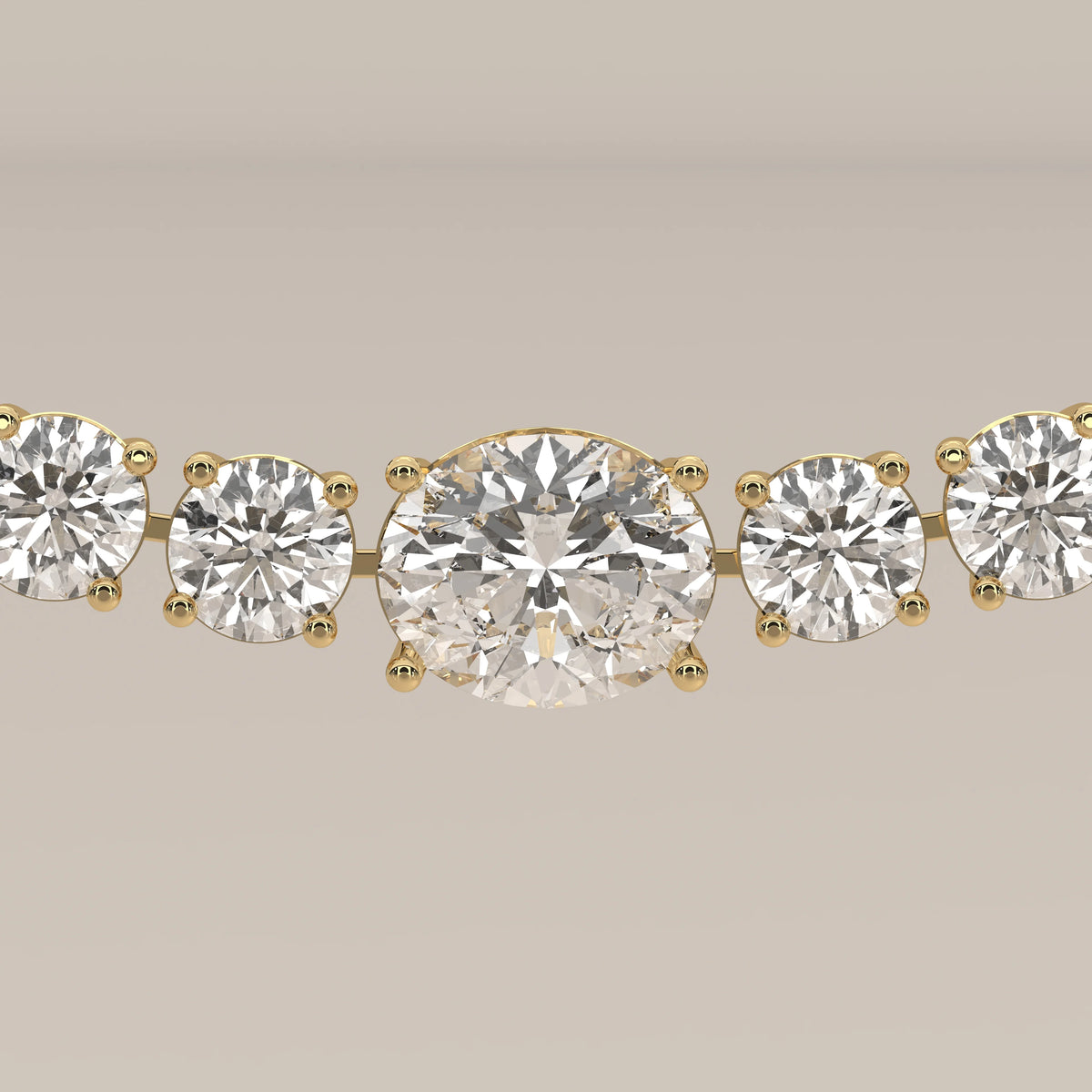 A graduated round lab grown diamond tennis necklace in yellow gold, photographed head-on.